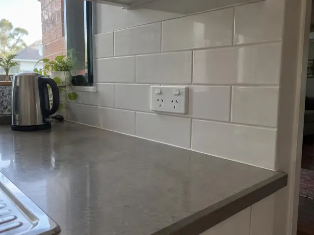White double power point on tiled kitchen splashback beside a window and benchtop in Cooks Hill